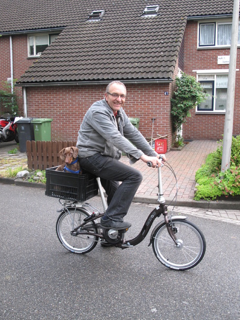 Nou, dit is helemaal vet gaaf. Mijn baas heeft een eigen stoeltje voor mij gemaakt op de .... eu, hoe heet dat .... fiets. Ze hebben mij verteld dat we wat langer weg gaan met het schip en ook fietsen. Dat noemen zij vakantie.
Op deze foto zijn wij aan het oefenen. Vindt dat wel heel leuk.